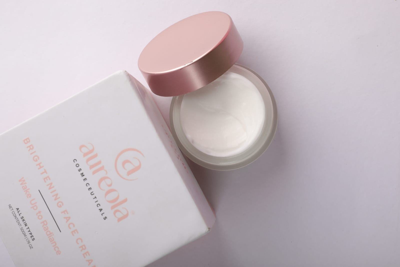 Aureola Brightening Cream open, showing rich white cream texture